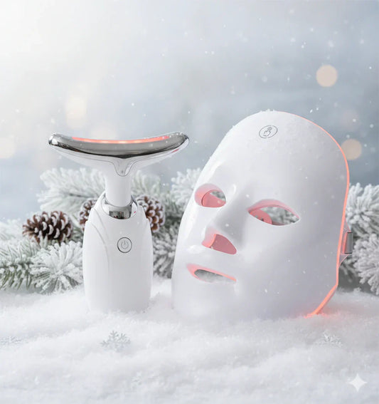 Revalio LED red light face mask and neck device resting in fresh winter snow with frosted pine branches, highlighting light therapy skincare for the colder season.