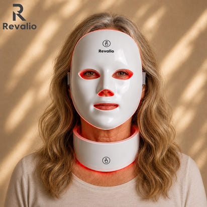 Woman wearing a Revalio LED face and neck mask on a beige background