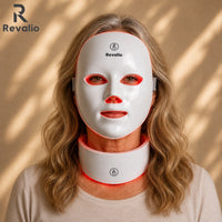 Woman wearing a Revalio LED face and neck mask on a beige background