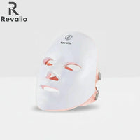 Revalio white LED face mask with Revalio branding on the top left corner on a light gray background