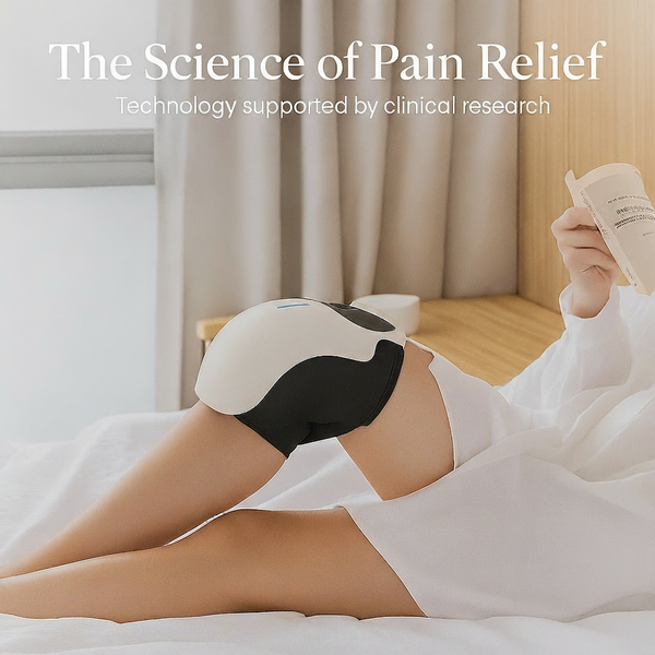 Woman relaxing on a bed and reading while wearing a smart heated knee massager, with the text “The Science of Pain Relief – technology supported by clinical research” at the top.