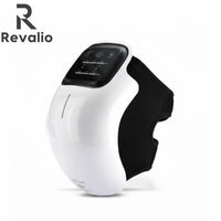 Front angled view of the Revalio Smart Knee Massager with white shell and black adjustable strap against a white background.